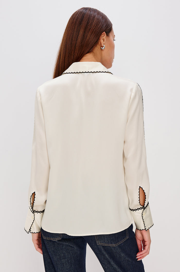 Aloise Collared Shirt in Silk Charmeuse With Scalloped Embroidery, Long Sleeves With Small Cutouts, and Adjustable Front Buttons in Ivory Colorway - Close Up Back View Featured on Model