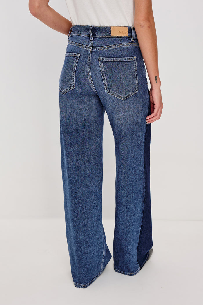 Angeleno Wide Leg Jeans With Mid-rise, Contrast Godet Inserts, Front Zip-Fly, and 5-Pocket Styling in Godet Indigo Grove Colorway - Lower Body Back VIew Featured on Model