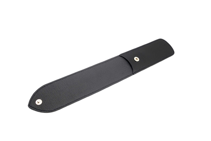Close-up of black leather straight razor case with snap button closure, designed for grooming tools