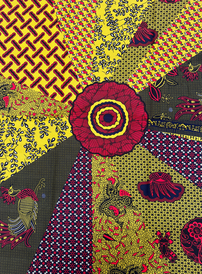 african Colorful fabric pattern with various designs including flowers and geometric shapes.