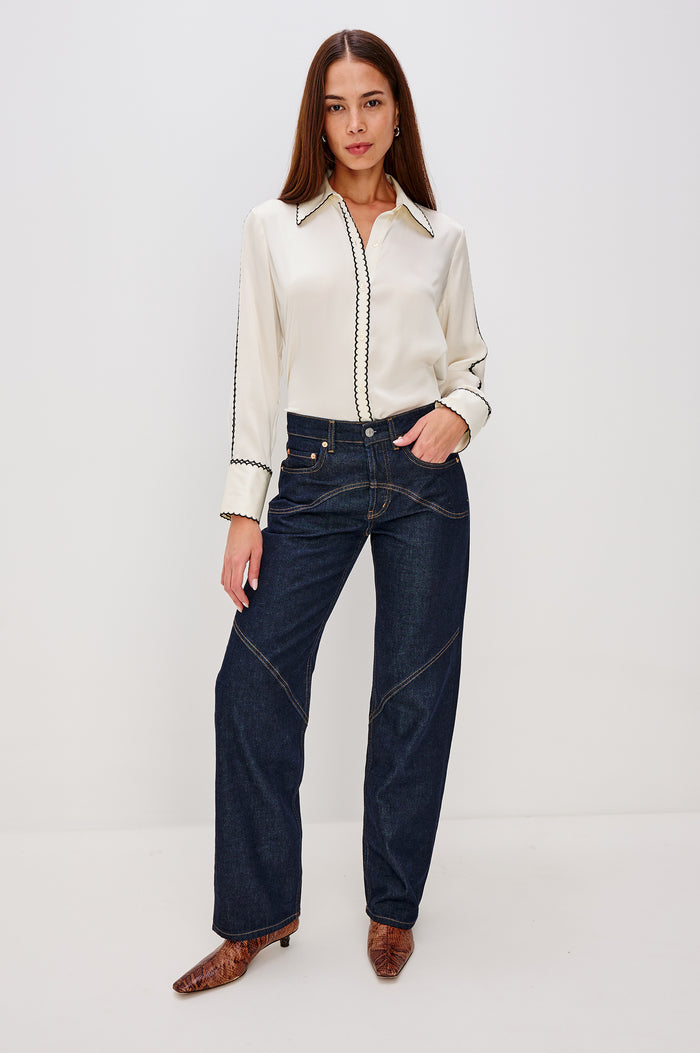 Aloise Collared Shirt in Silk Charmeuse With Scalloped Embroidery, Long Sleeves With Small Cutouts, and Adjustable Front Buttons in Ivory Colorway - Full Body Front View Featured on Model