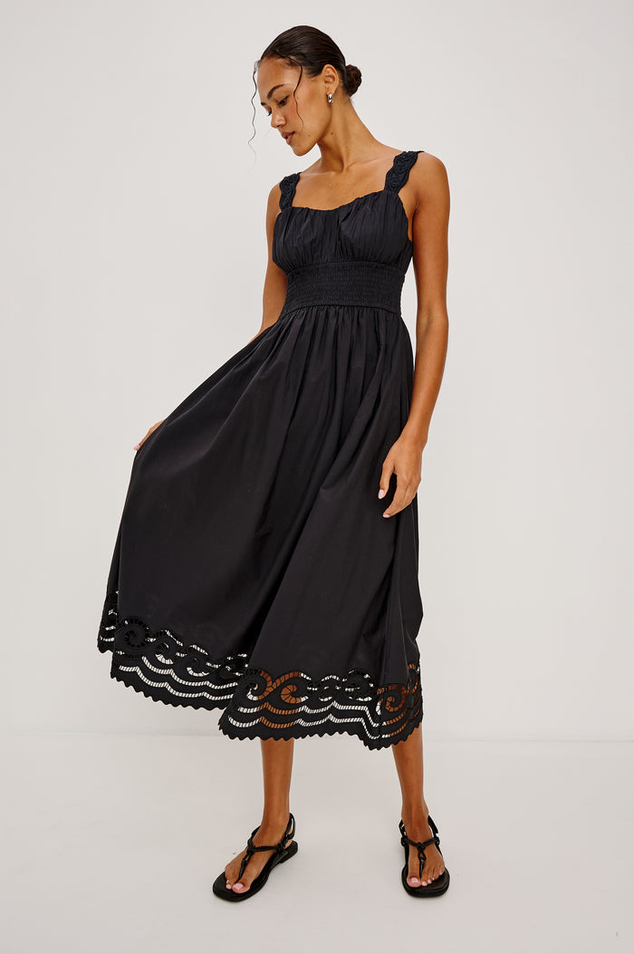 Anadia Maxi Dress in Poplin With Soutached Swirl Shoulder Straps, Ruched Bust, Smocked Empire Waist, and Scalloped Ladder Embroidered Hem in Black Colorway - Full Body Front View Featured on Model
