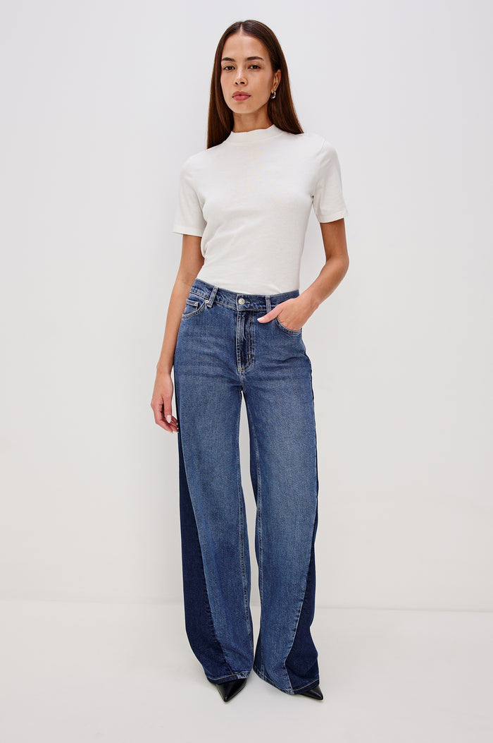 Angeleno Wide Leg Jeans With Mid-rise, Contrast Godet Inserts, Front Zip-Fly, and 5-Pocket Styling in Godet Indigo Grove Colorway - Full Body Front VIew Featured on Model