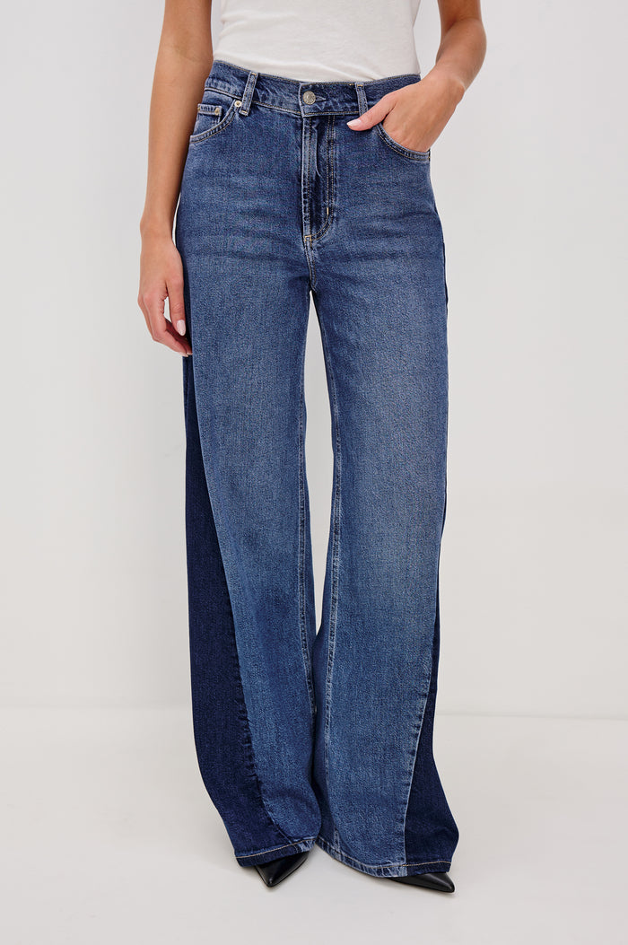 Angeleno Wide Leg Jeans With Mid-rise, Contrast Godet Inserts, Front Zip-Fly, and 5-Pocket Styling in Godet Indigo Grove Colorway - Lower Body Front VIew Featured on Model