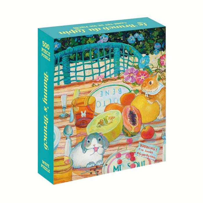 The WEVE Bunny's Brunch 500 piece jigsaw puzzle is made from recycled paper and premium blue board, showcasing a vibrant picnic scene with fruit, a guinea pig, a hamster, and brunch items on the table.