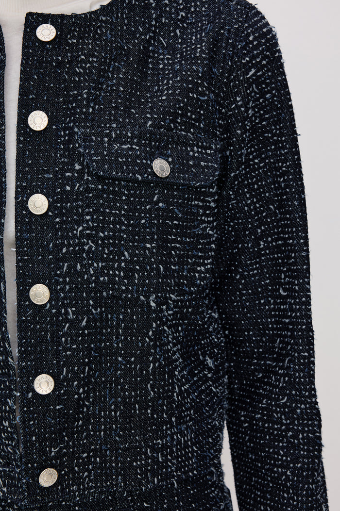 Capistrano Cropped Jacket in Denim Tweed Texture With Crew Neckline, Front Buttons, Buttoned Chest Pockets, and Long Sleeves in Denim Tweed Colorway - Upper Body Front Close Up View Featured on Model