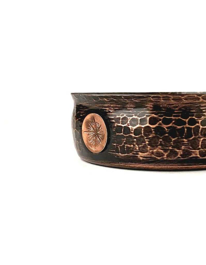 Close-up of copper emblem on copper shave bowl with textured exterior