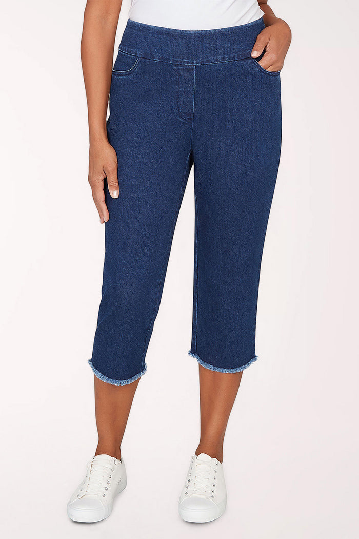 Woman wearing a dark denim crop pant.