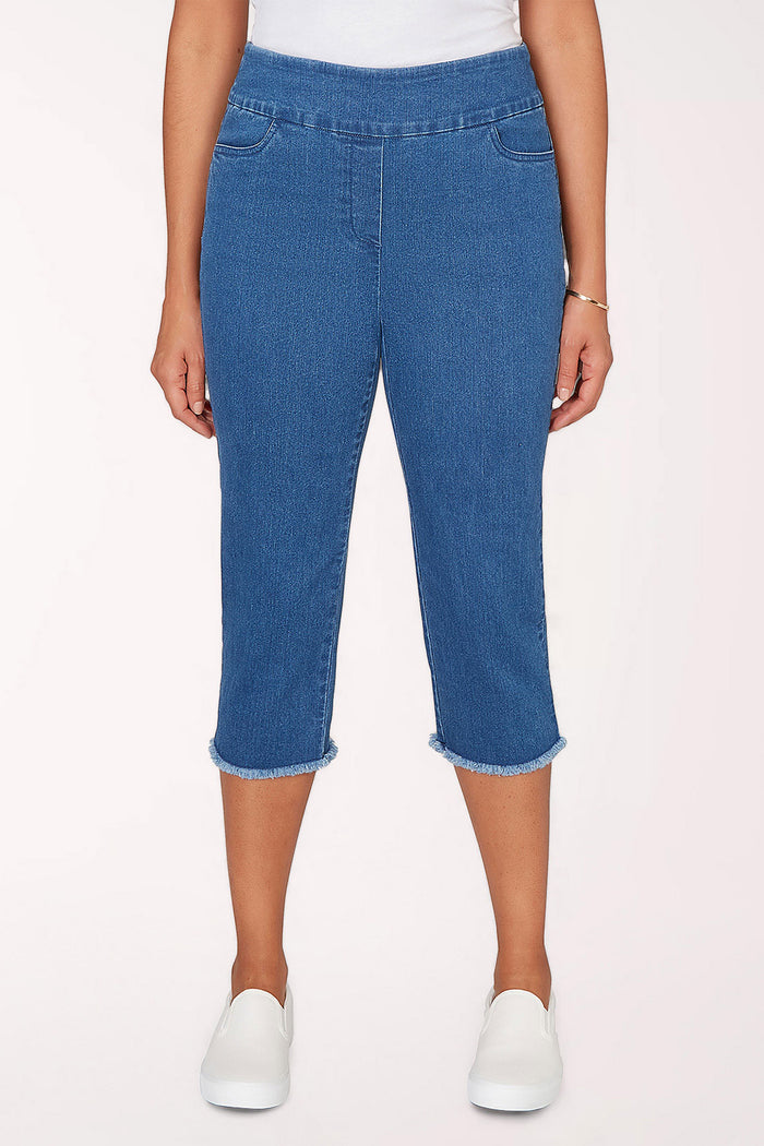 Woman wearing a medium denim crop pant.