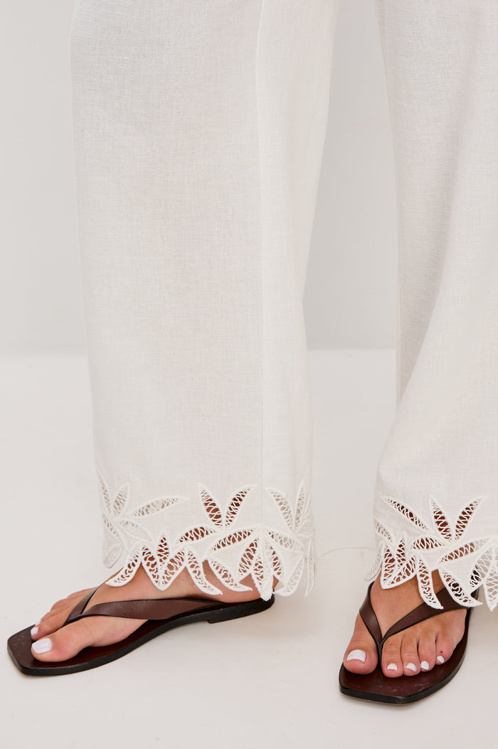 Emmie Straight Leg Pant with Adjustable Drawstring at Waist in White Palm Embroidery Colorway. Close Up View Shown on Model.