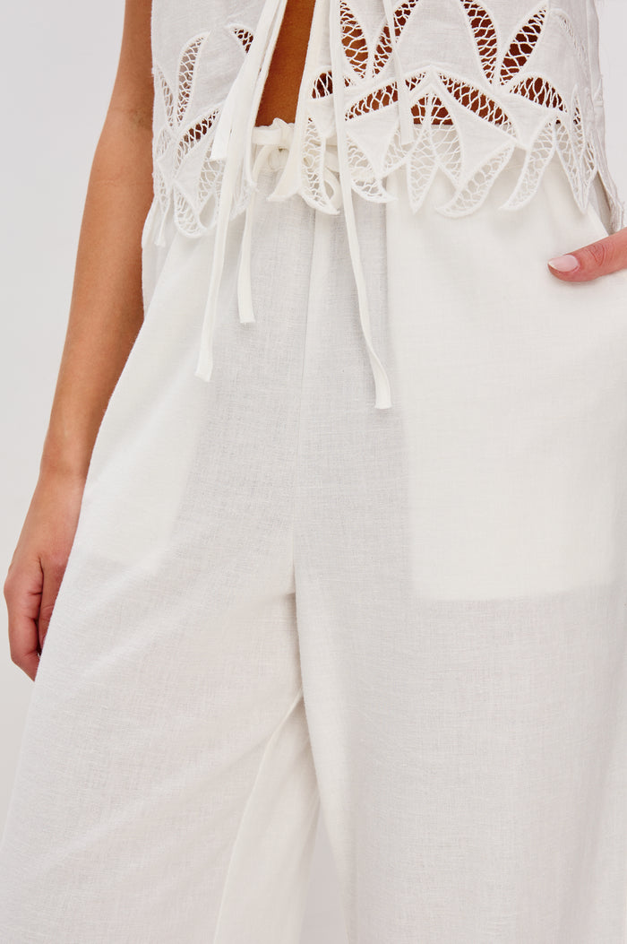 Emmie Straight Leg Pant with Adjustable Drawstring at Waist in White Palm Embroidery Colorway. Close Up View Shown on Model.