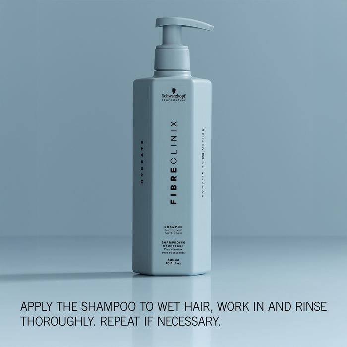 Fibre Clinix Shampoo bottle on a light blue background with application text along the bottom
