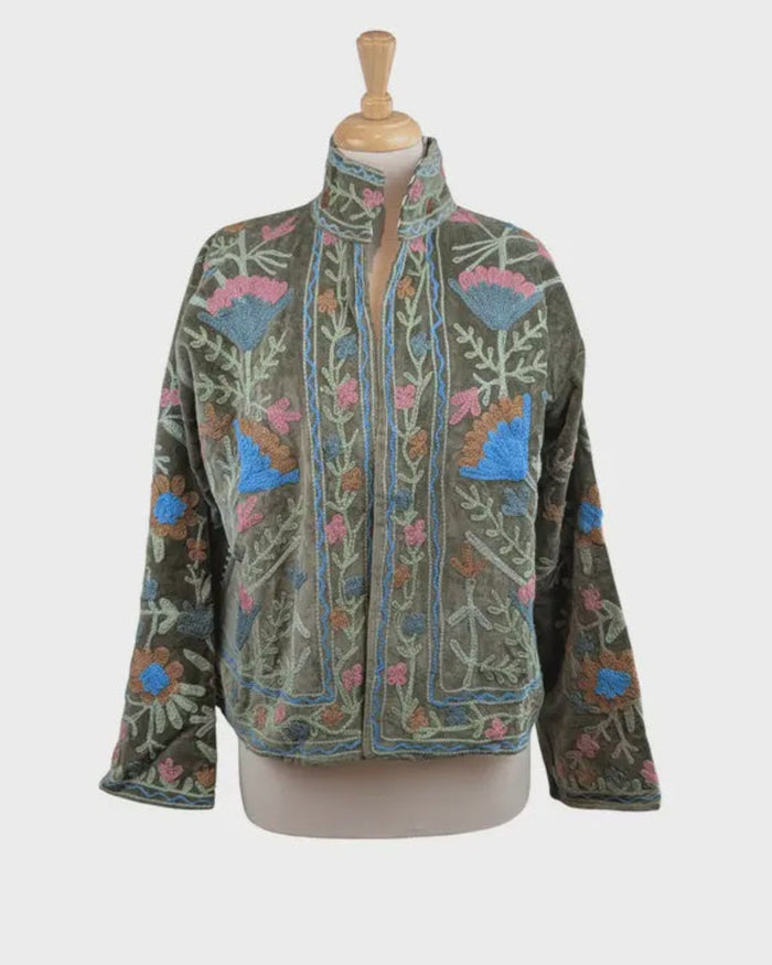 Embroidered jacket on a mannequin against a white background