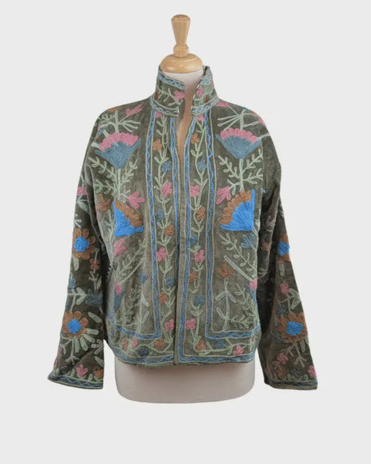 Embroidered jacket on a mannequin against a white background