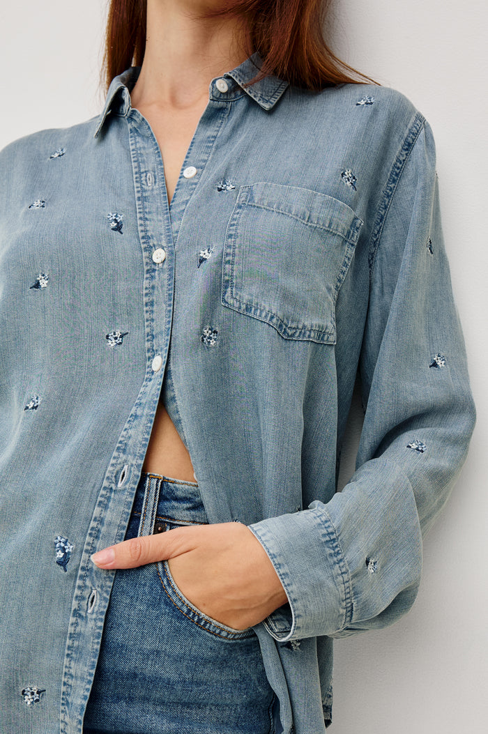 Ingrid Button-Up Collared Shirt in TENCEL™Denim With Vintage-Inspired Wash, Floral Embroidery, a Chest Patch Pocket, and Long Sleeves in Blossoms Colorway - Upper Body Close Up Front View Featured on Model