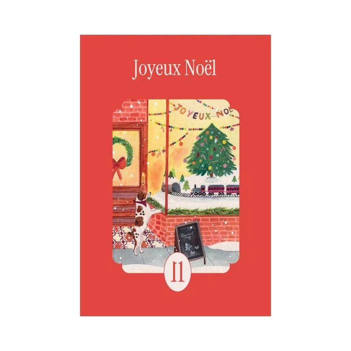 The la pauz Joyeux Noël | 99 Piece Jigsaw Puzzle features a festive holiday scene with a Christmas tree, train set, dog by the window, and Chocolat Chaud chalkboard—a charming and merry mini puzzle perfect for the season.