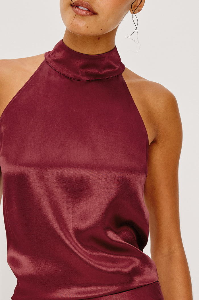 Leah Halter Top in Satin Crepe With a High Neckline, Sleevleless Cut, Back Button Neck Closure in Garnet Colorway - Upper Body Close Up View Featured on Model