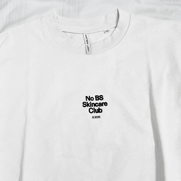 White t-shirt with 'No BS Skincare Club' text on a white background